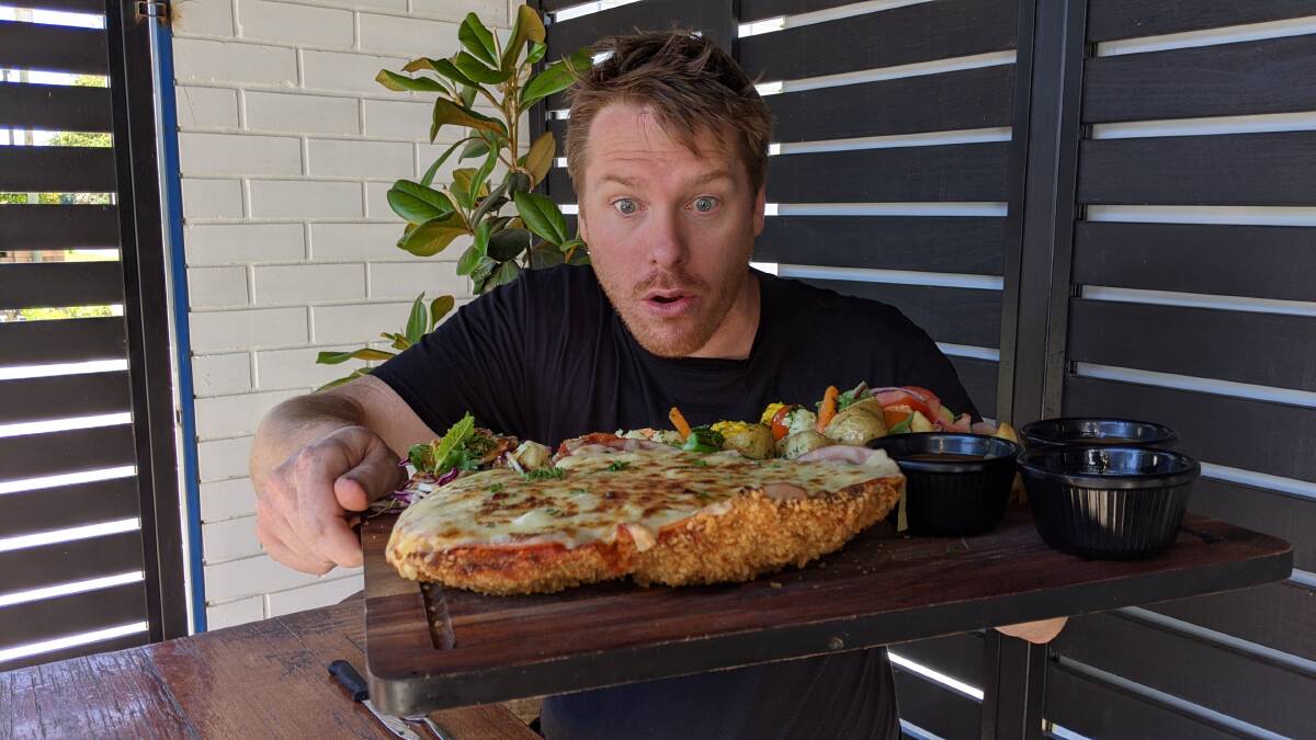 BIG BITE: Alo Baker took on the Palm and Pawn's 1kg chicken parmi challenge. Picture: Contributed
