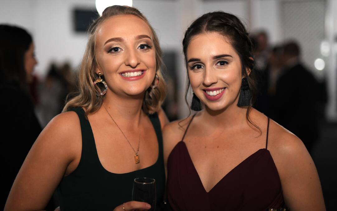 MADE UP: Maddy Dowd and friend Kimberly Hennessy get dressed to the nines for the Winter Ball.