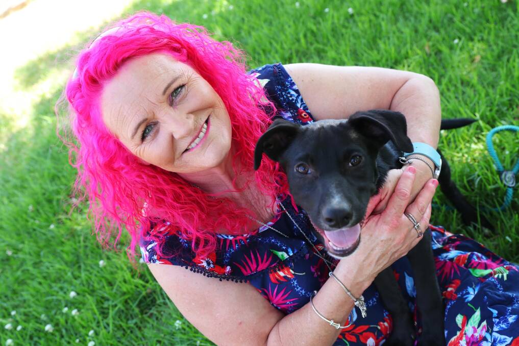 LUSCIOUS LOCKS: Wagga local Kim Bosley plays with Tommy the kelpie pup before her big shave to raise money for Best Friends Pet Rescue. Picture: Emma Hillier.