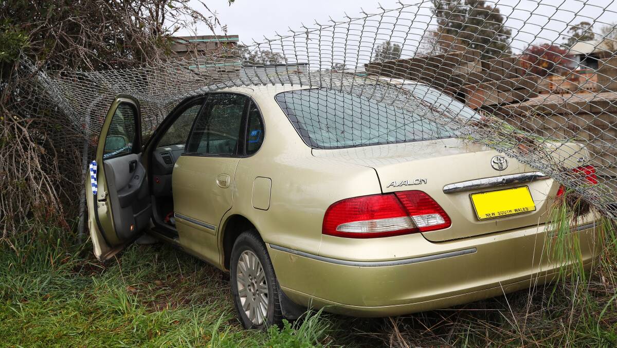 CRASH: The gold Toyota Avalon crashed into a fence along Pearson Street with police in tow. Picture: Emma Hillier