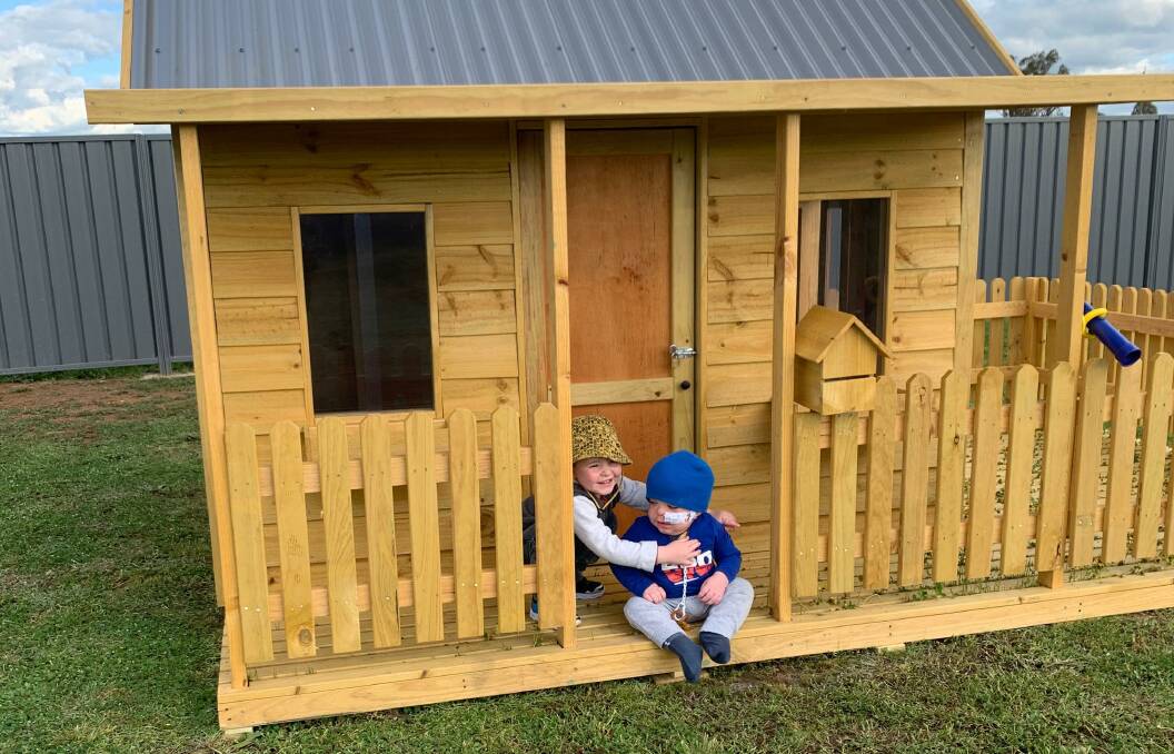 TOGETHER AGAIN: Darcy, 3, and Henley Carey, 1, explore their new cubby house courtesy of Wagga's St George Bank. Picture: Contributed