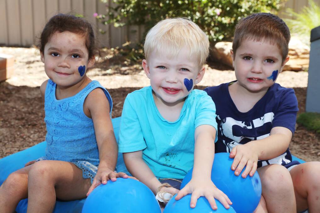 HELPING HANDS: Dustin got the support of his classmates, including Zahra Vuetivavalaqi, 3 and Joshua Merlino, 3, to raise awareness for CHD on 'Blue Day'. Picture: Emma Hillier
