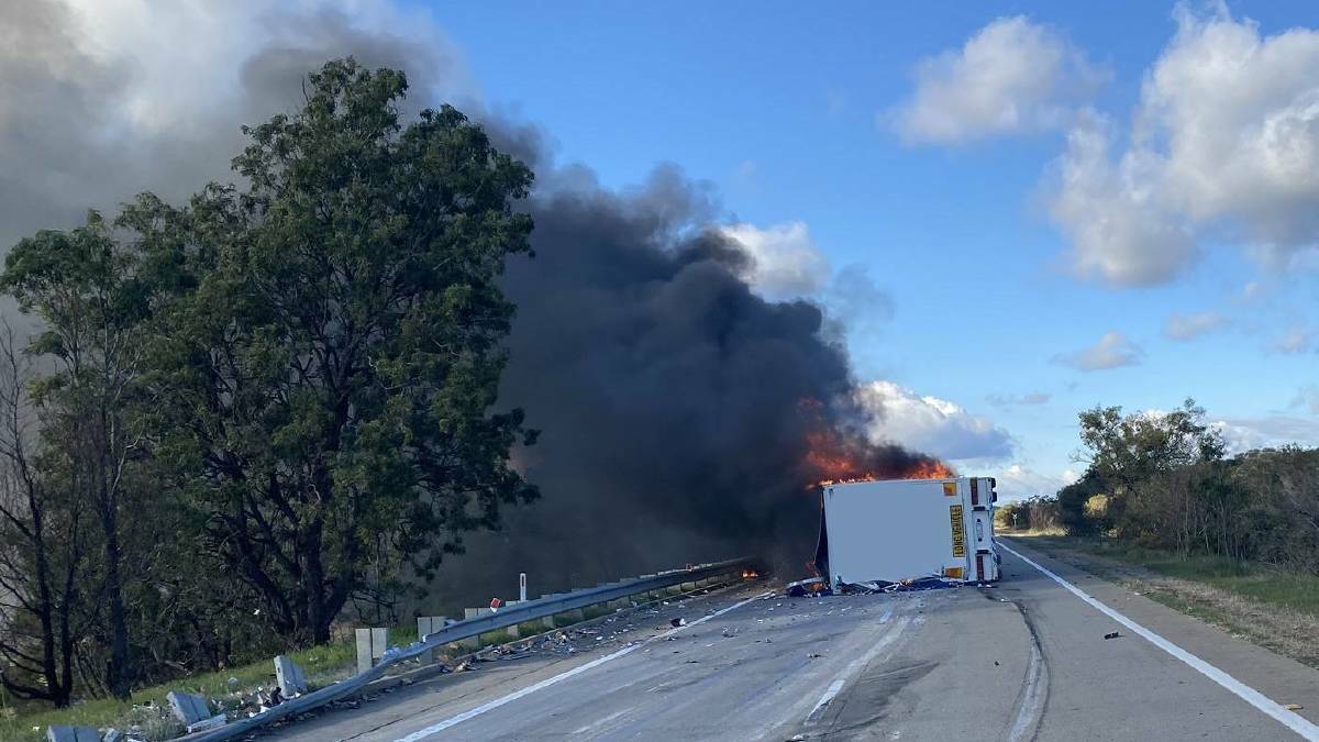 A truck that rolled and caught fire on the Hume Highway at Berremangra, north of Gundagai on Wednesday afternoon. Picture: Live Traffic NSW