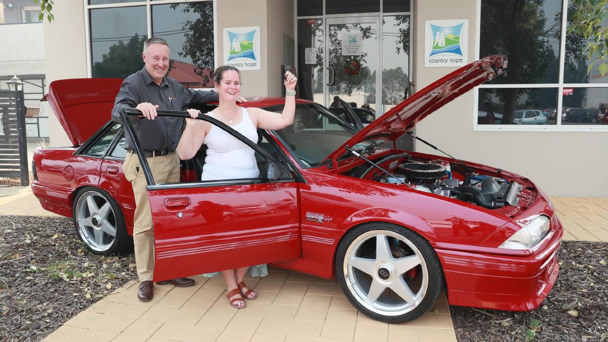 SWEET RIDE: Scott Brideoake hands over the keys of the Commodore to proud new owner, Fiona Dawson. Picture: Les Smith