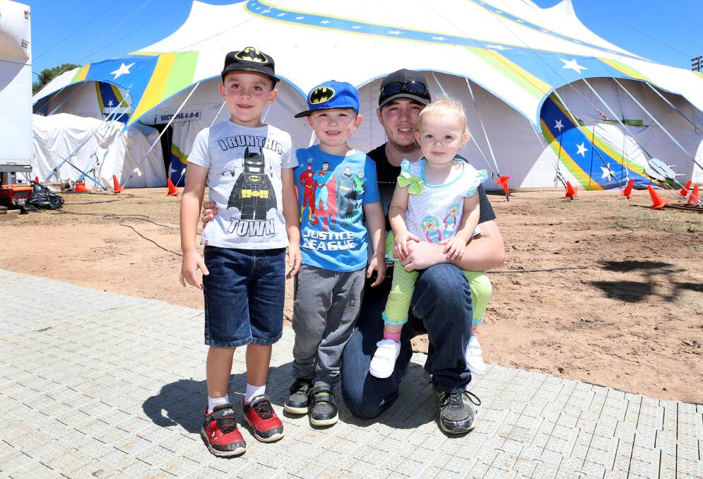 5 yo Phillip Quarmby from Batlow (L) with 4 yo Jayden Gibson, Matt Gibson and 2 yo Hayley Gibson, from Tumbarumba enjoy a day at the circus. Picture: Les Smith