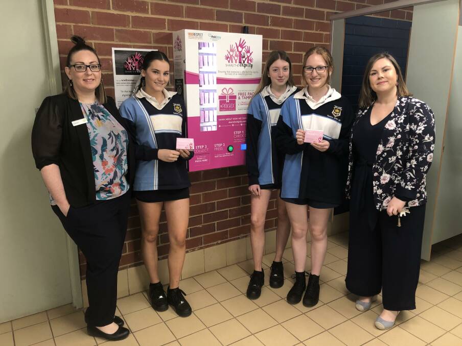 Lauren Rodway, Belle Maher, Laura Phillips, Montana Dasey and Megan McGrath test out the Pink Box vending machine.