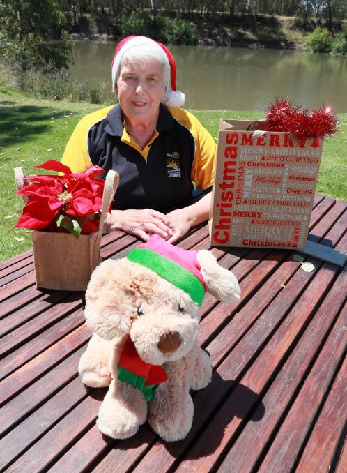 FESTIVE: Service director of Wagga Sunrise Rotary Joan Skews gears up for the Christmas tree sale. Picture: Les Smith