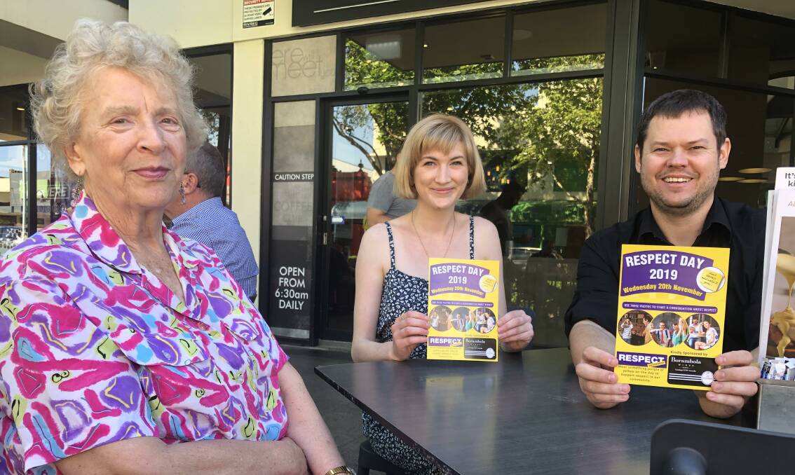 Ronda Lampe and Kate Wall of Respect Awareness hand over the posters to Coffee Club owner Ben Phillips. Picture: Jessica McLaughlin