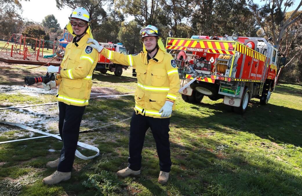 Mark Wardman, 18, and Thomas Carey, 15, use the fire hose in a drill for the PCYC cadet program. Picture: Les Smith