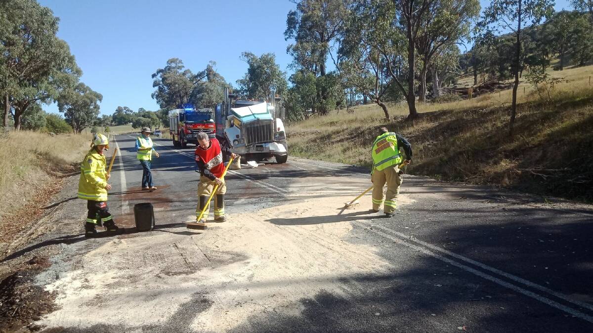 Fire and Rescue clear the fuel spillage on Tooma Road. Picture: FRNSW