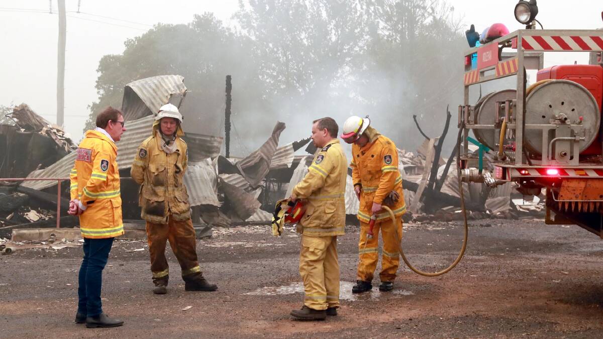 SUPPORT: Wagga MP Joe McGirr talks to firefighters at Batlow's old hospital site in the wake of the Dunns Road bushfire in January. Picture: Les Smith