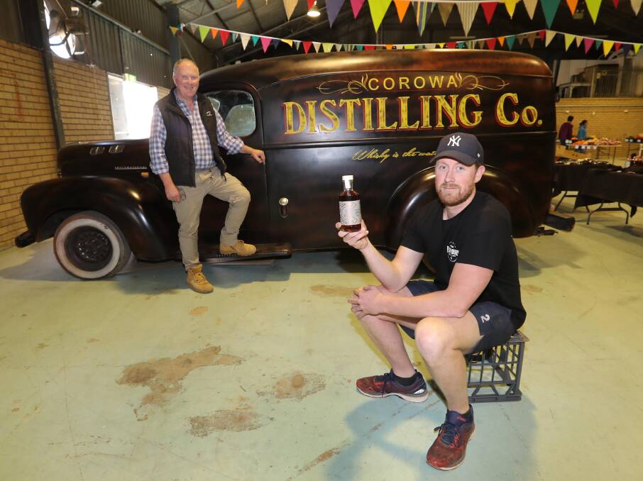 Niel and Dean Druce with the finished brew from Corowa Whisky Distillery. 