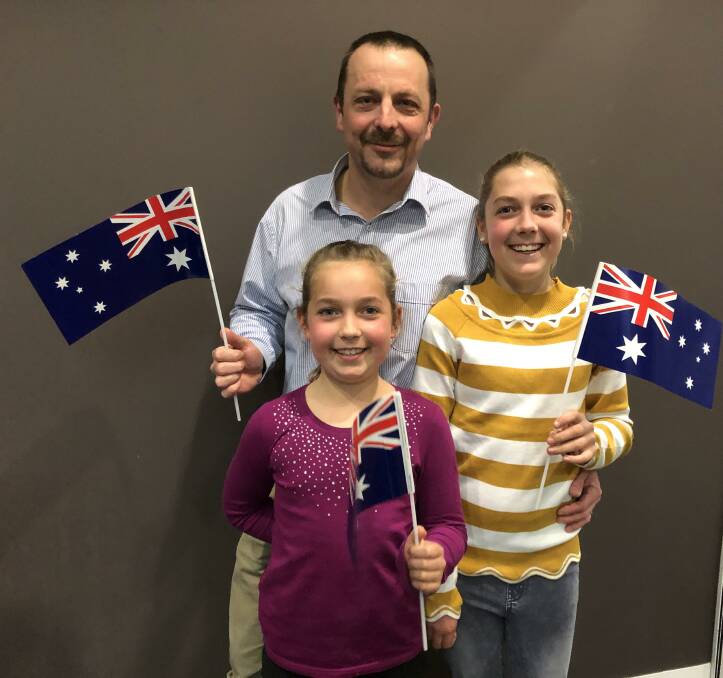 AUSSIE, AUSSIE, AUSSIE: Simon Matthews with daughters Phoebe, 9, and Freya, 12, show their Aussie pride after officially becoming Australian citizens. Picture: Jessica McLaughlin