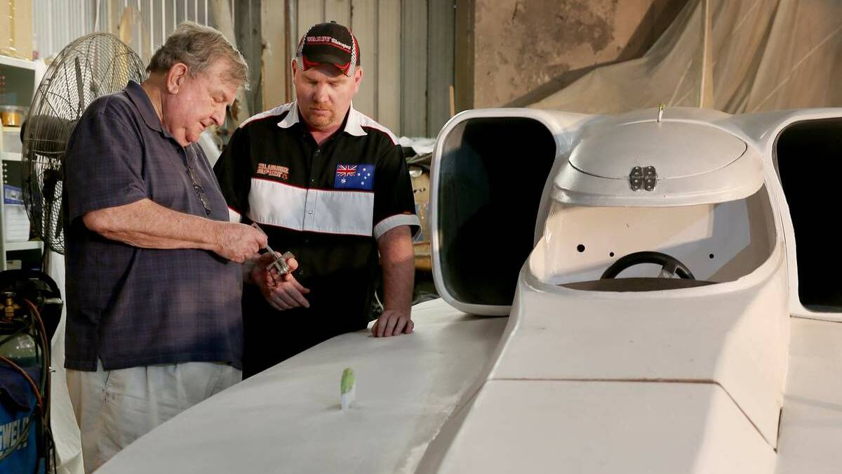 SPEEDSTERS: Ken Warby, left, with son David, putting the finishing touches to Spirit of Australia II in a warehouse in Wickham back in 2016.