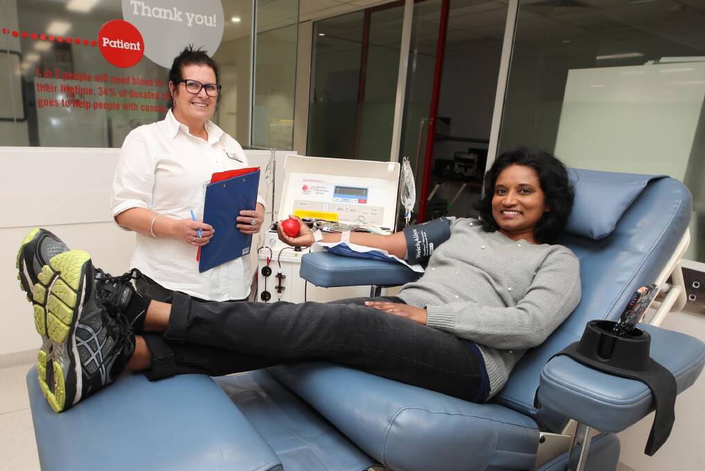 GIFT OF LIFE: Registered Nurse Megan O'Rourke facilitates Asha Mendis' blood donation. Picture: Les Smith
