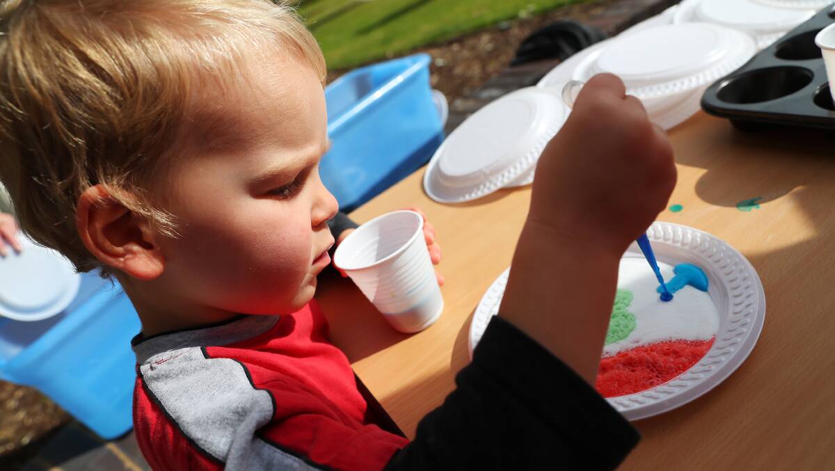 COLOURFUL CHEMISTRY: Stirling Scott, 3, celebrates his birthday by making colourful foam at the science festival. Picture: Emma Hillier