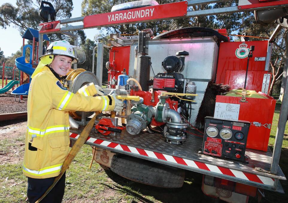 Rebel Brooker, 16, tends to the water pump on the back of the RFS truck. Picture: Les Smith