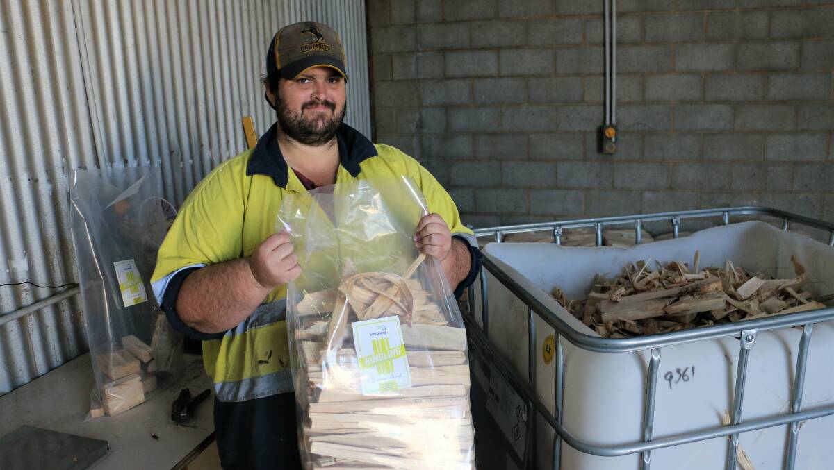 NEXT UP: Once the timber off-cuts have been split, Matt Wilson weighs them out into 7kg bags before they go on to be stickered. Picture: Jessica McLaughlin