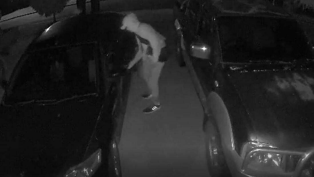 CAUGHT: A man is seen trying to break into two vehicles in Glenfield Park. Picture: Contributed