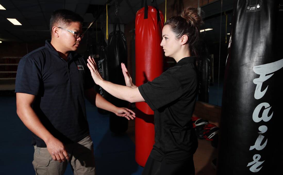 David Bardos and Caitlin Langley work together to perfect their self defence skills. Picture: Les Smith