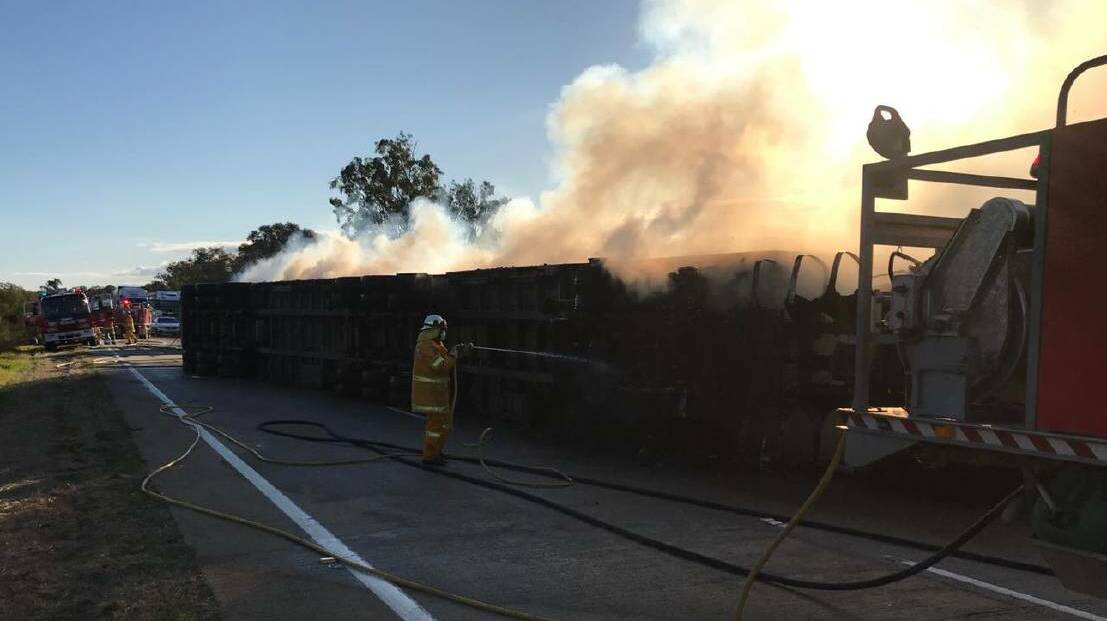 NSW Rural Fire Service attends a truck that rolled and caught fire on the Hume Highway at Berremangra, north of Gundagai on Wednesday afternoon. Picture: Sam Kelly - NSW RFS
