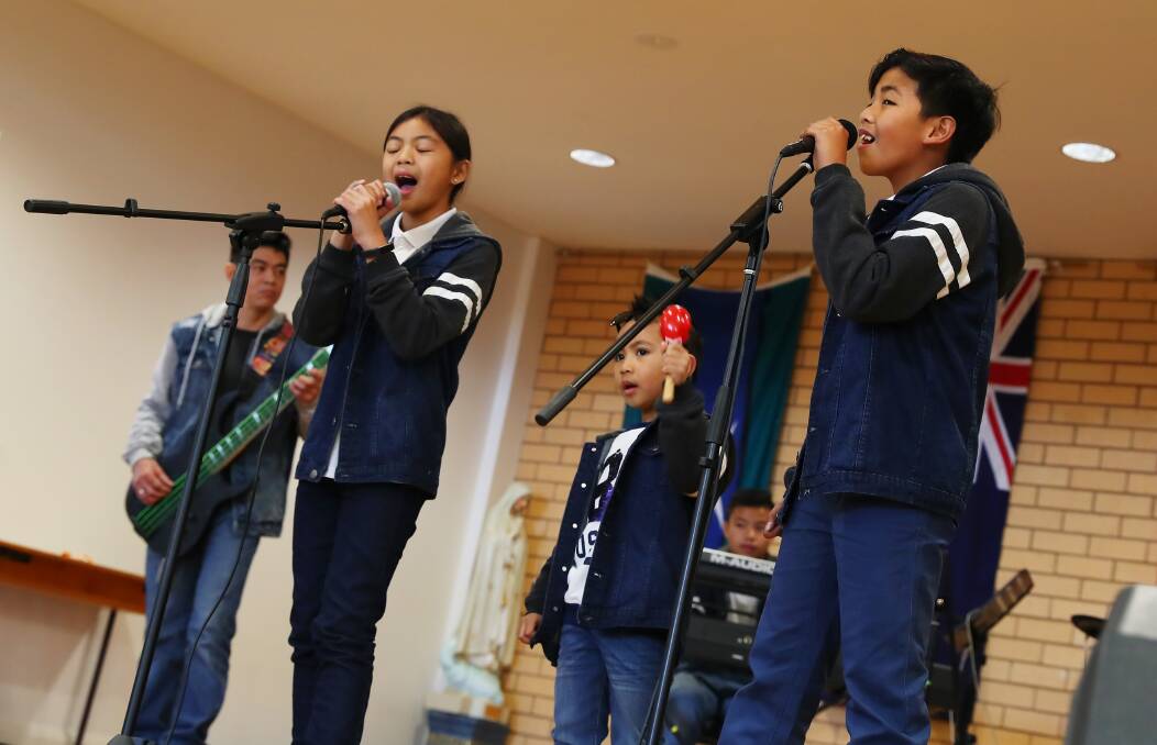 Ysabella Borja, 10, Joz Pastor, 5 and Paolo Cumla, 11, perform for their friends, family and fellow community members. Picture: Emma Hillier