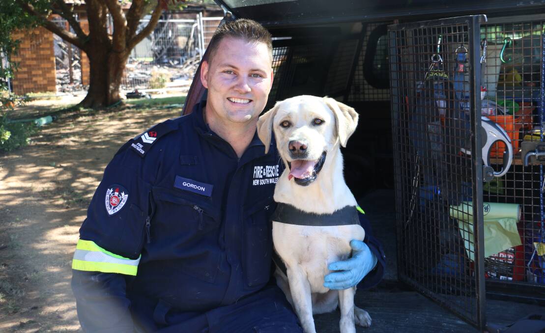 CATCH A SCENT: Craig Gordon was assisted by Xenos the Labrador to investigate the site of a house fire in Ashmont. Picture: Jessica McLaughlin