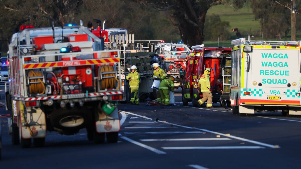 TRAGEDY: Paramedics, firefighting crews, police and Volunteer Rescue Association squads at the scene of the truck and car accident near the intersection of Tumbarumba Road and the Sturt Highway on Sunday. Picture: Emma Hillier