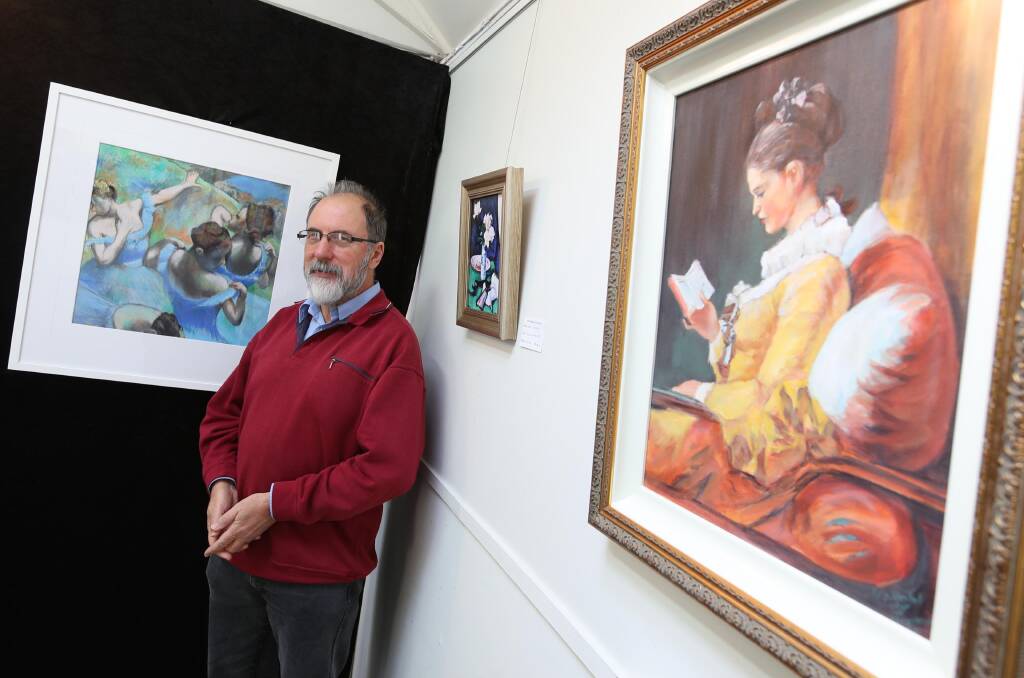 Secretary Geoff Fellows with some of the art on display. Picture: Les Smith
