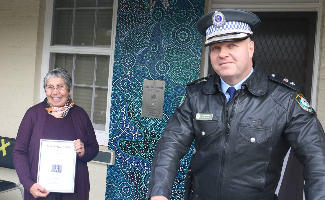 UNITY: Wiradjuri Elder Aunty Sonia Piper shows off the new Aboriginal artwork at the Gundagai Police Station with Superintendent Bob Noble. Picture: Jessica McLaughlin