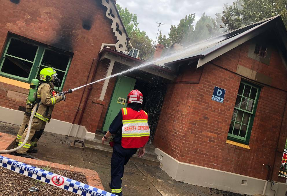 Firefighters work hard to extinguish the blaze that destroyed multiple classrooms at Wagga Public School last weekend.