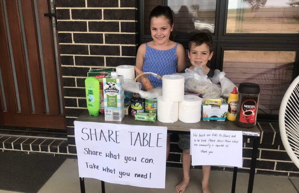 KIND HEARTS: Brooke, 7, and Mason Mouat, 5, help spread community spirit at their family's 'share table' in Gobbagombalin. Picture: Jessica McLaughlin