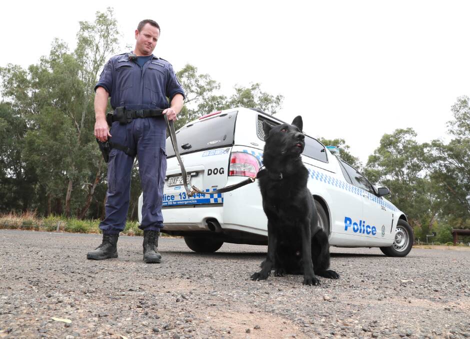 PATROLLING: Senior Constable Karl Harris and Buster the police dog have each others' backs to keep Wagga safe. Picture: Les Smith