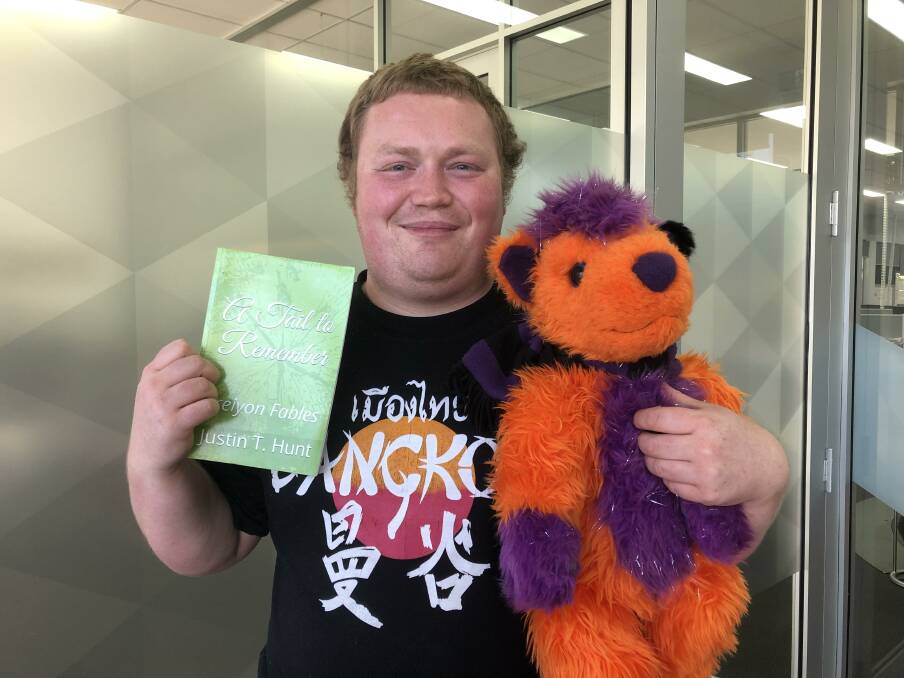 Justin Hunt with the First Edition of 'A Tail to Remember' (now with a new cover), and Chester the Fox who features in the final book of the Trilogy, 'Hooked on Power'.