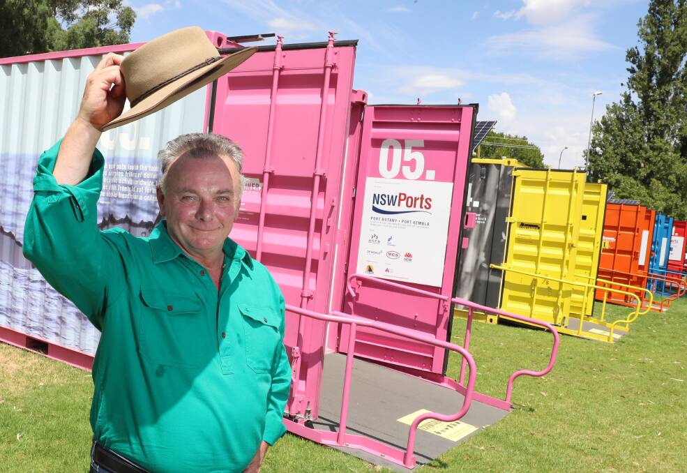 The Museum's Luke Grealy poses with the brightly coloured shipping containers outside the Visitor Information Centre. Photo: Les Smith