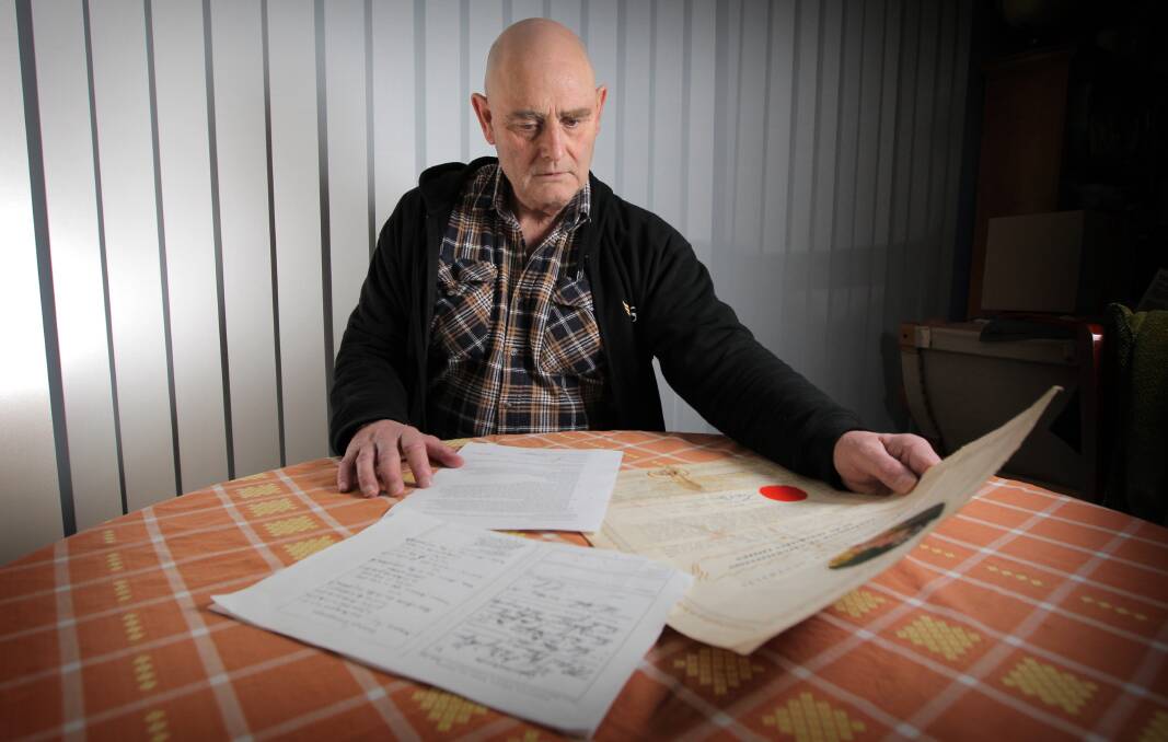 Michael Kramer with his birth certificate and citizenship documents in 2013. Picture: The Border Mail 2013