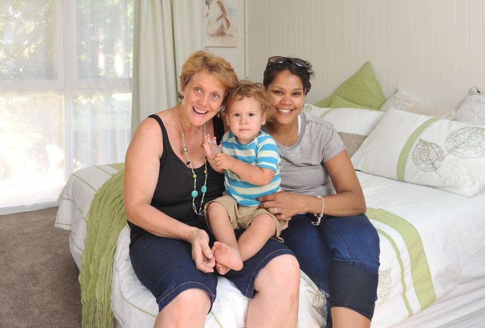 BLITZED: Lisa Saffery (left) with Sarah Williams and their 2-year-old son Yarrul in their newly refurbished bedroom