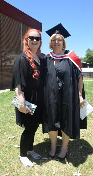 BALANCING ACT: Debra Fisher with her daughter Veronica at Charles Sturt University after graduating with a Masters of Social Work (Professional Qualifying).