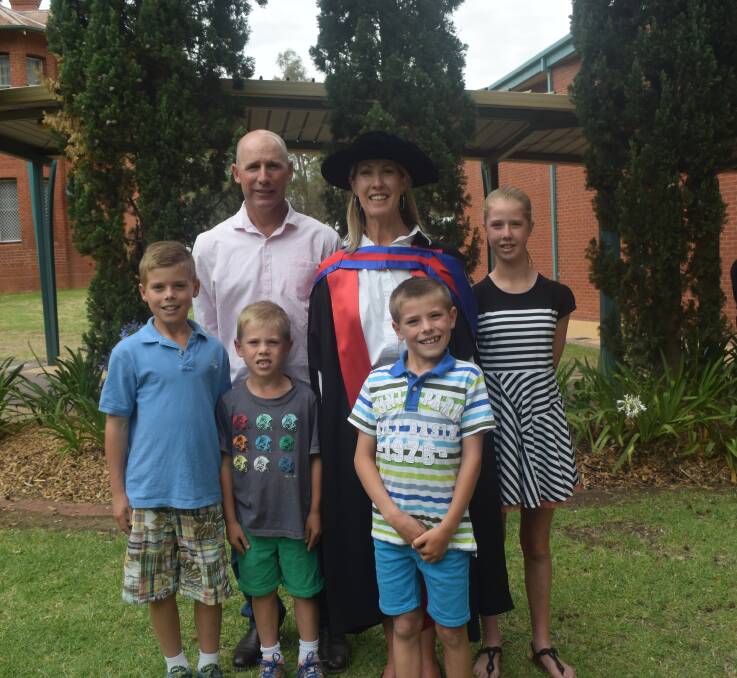 MOTHERHOOD: Stacey Jenkins was awarded her PhD, which she completed over 10 years in which she had four children. Stacey Jenkins (centre) with family: (from left) Hugh, 10, husband Drew, Vaughn, 7, Finn, 8, and Zoe, 11.