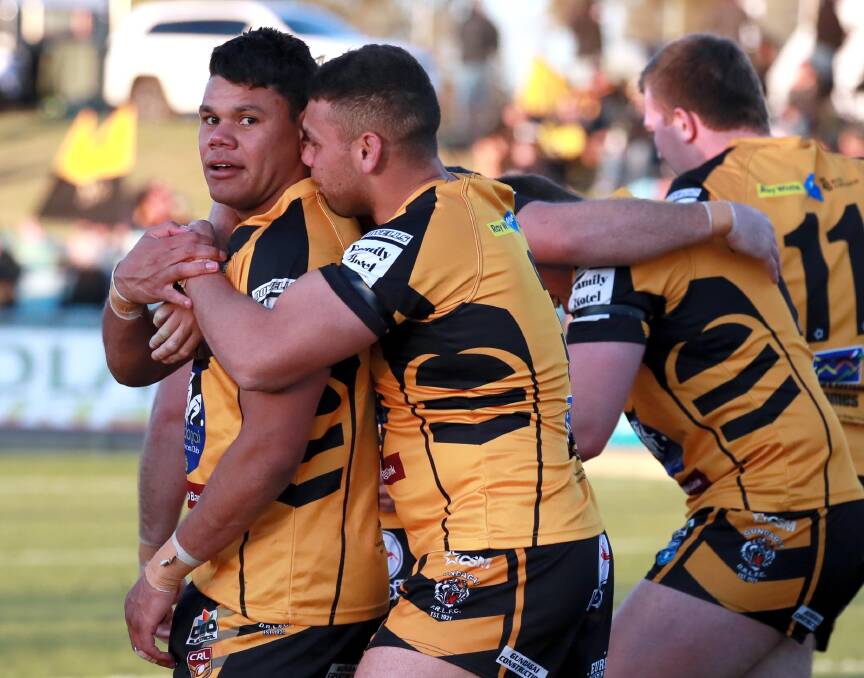 Jack and Mathew Lyons celebrate after scoring five tries between them in the Group Nine grand final.