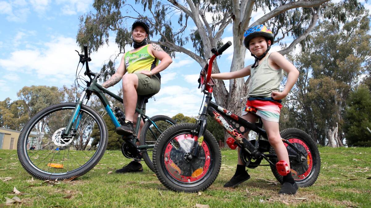 Noel Smith and his six-year-old son Ace Smith enjoy a bike ride in Wagga on Sunday. Picture: Les Smith