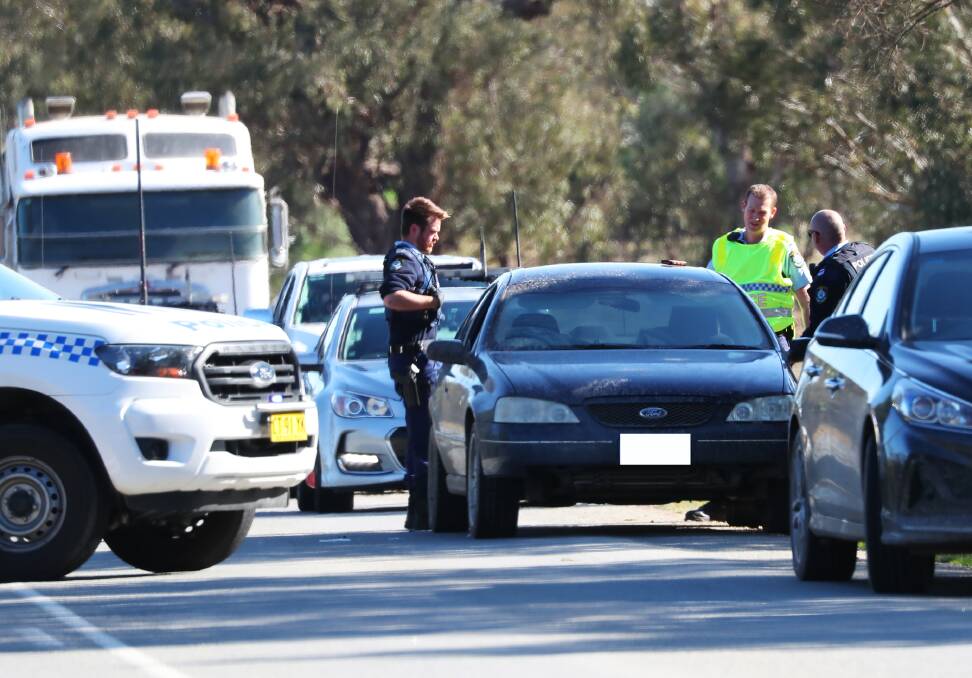 Police on Old Narrandera Road at Euberta. Corey Edward Matthew Bennett was arrested after a police chase ended when a blue Ford Falcon sedan ran out of fuel. Picture: Emma Hillier 