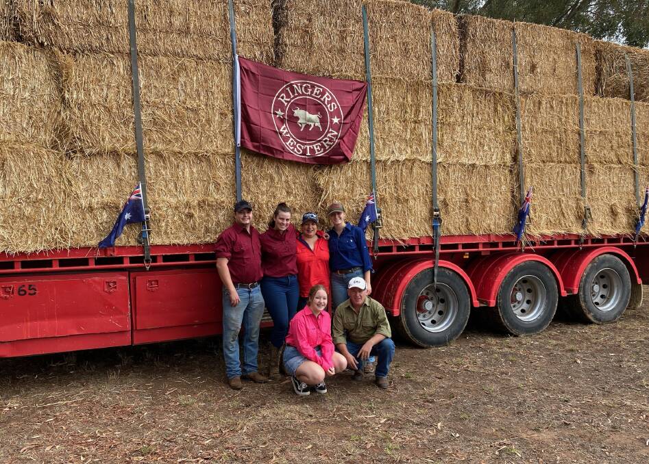 HELPING HANDS: Burrumbuttock Hay Runners Barb Konstantakis, Shane Bourke, Jess-Lee Hanley, Jacob Williams, Cleo Bourke and Maddy Kiernan with a much-needed load of hay delivered to Armidale on Saturday. Picture: Supplied