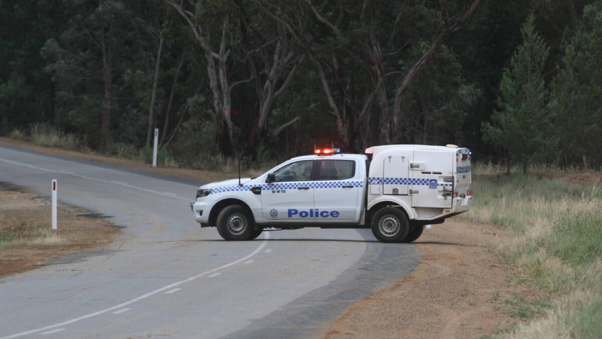 A police vehicle blocks Gregadoo East Road at Gregadoo following a crash on Sunday afternoon. Picture: Daisy Huntly