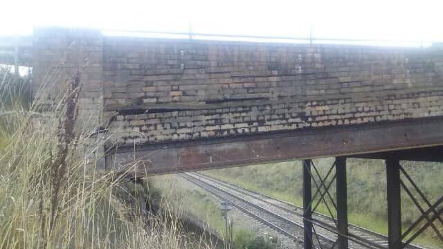 The damaged Burley Griffin Way bridge over the railway line at Wallendbeen. Picture: Steph Cooke