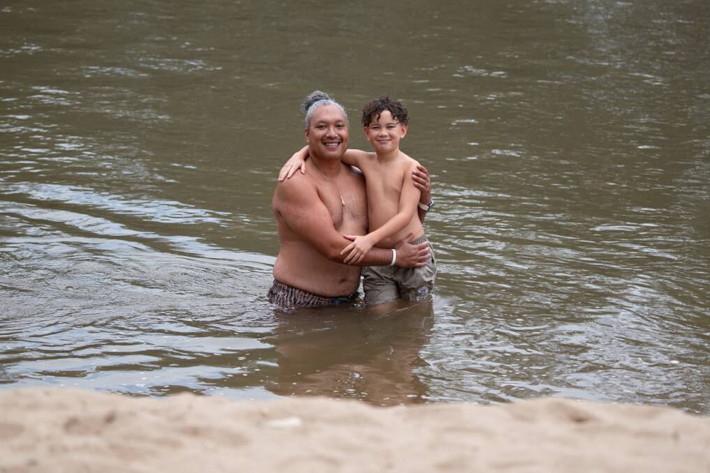 Jermaine Tuua and his nine-year-old son Jahree, from Junee, enjoy a refreshing swim in the Murrumbidgee River at Wagga Beach on Sunday. Picture by Madeline Begley 