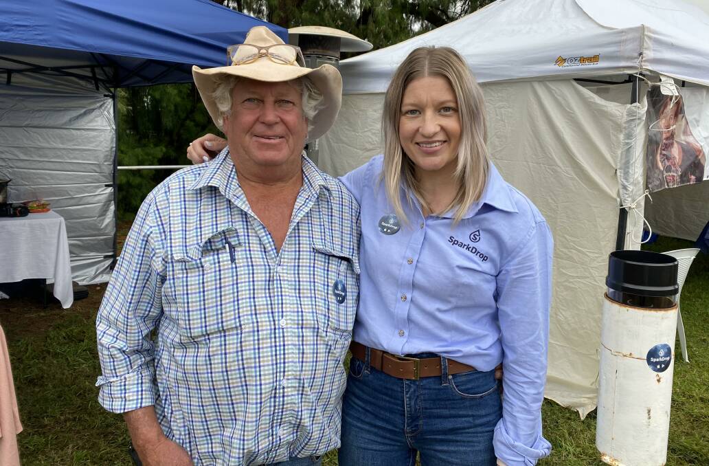 Sarah Armstrong, the creator of rainfall measurement and comparison app, Sparkdrop, with her dad Mick Armstrong at the Riverina Field Days in Griffith.