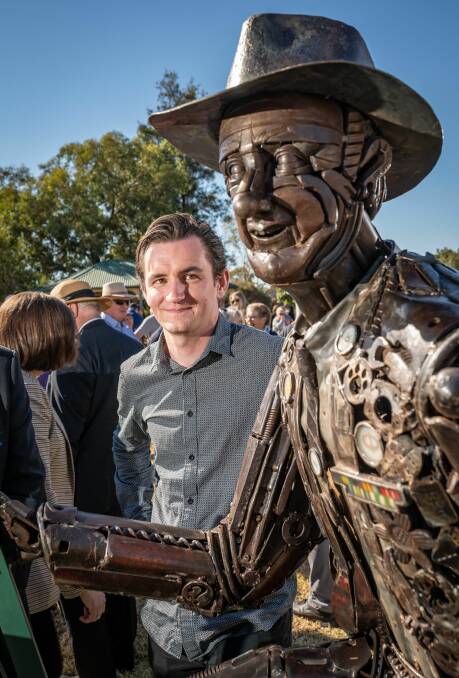 Awe-inducing: Dominic Fisher examines the statue of his father which consists of salvaged metal pieces.