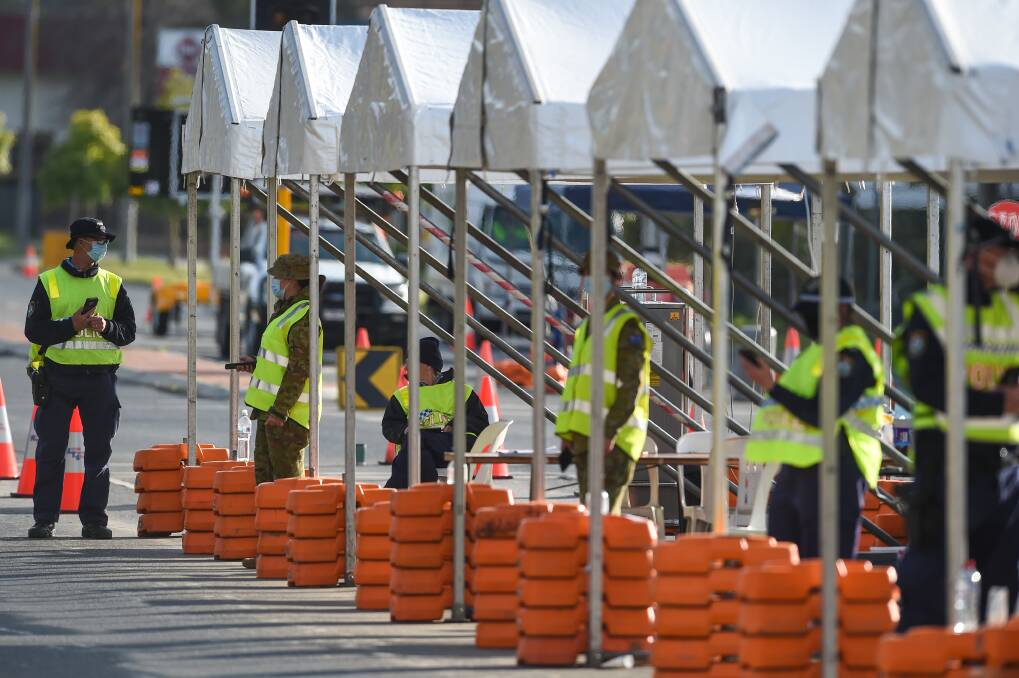 COMMON SIGHT: Police and Defence personnel wait at the Wodonga Place checkpoint in South Albury. Picture: FILE
