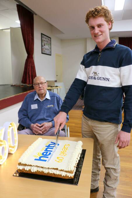 Henty Machinery Field Days Co-operative's youngest and fourth generation member Austin Scheetz, 19, of Culcairn, cuts the 60-year anniversary cake with the co-operative's oldest living member, Len Schilg, 92, of West Albury, and formerly farming at Brocklesby. Picture supplied